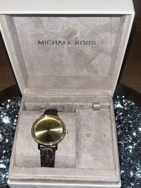 Michael Kors Brown monogram women’s watch.